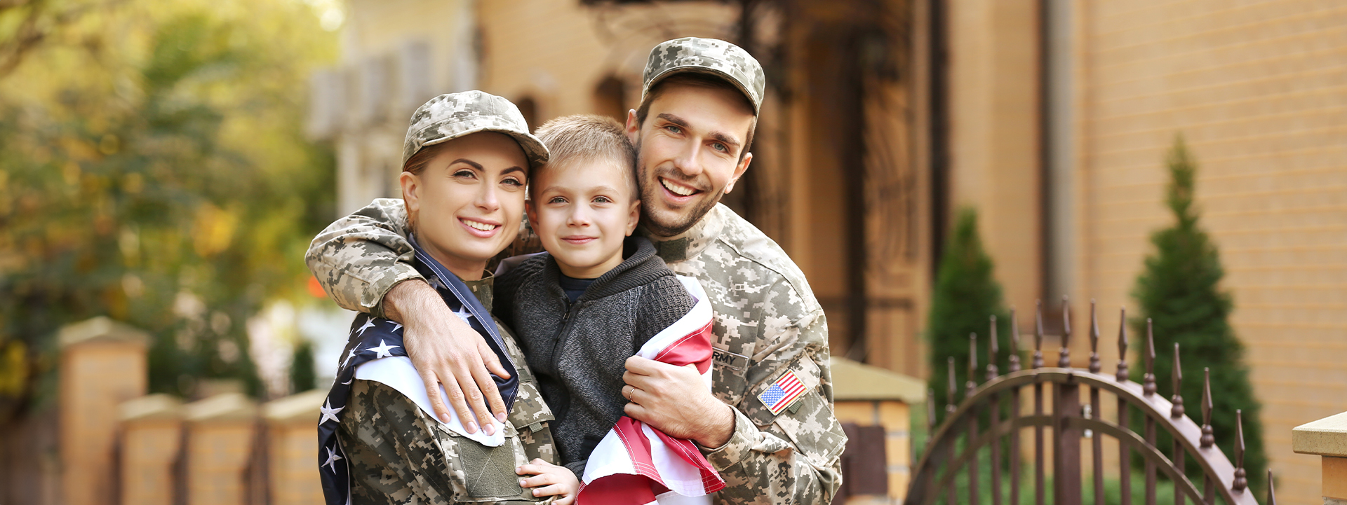 VA Loans in Flushing, NY military parents hugging their son outside their home